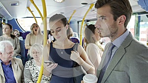 Passengers Standing On Busy Commuter Bus