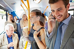 Passengers Standing On Busy Commuter Bus photo
