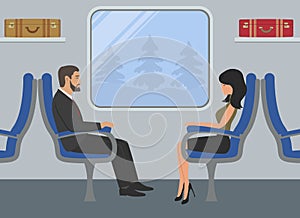 Passengers in the train car. Young woman and a man are sitting in blue armchairs and looking out the window