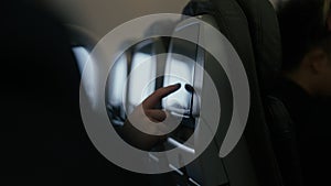 Passengers use entertainment system on plane seat