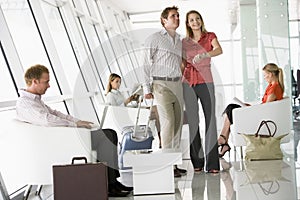 Passengers waiting in airport departure lounge photo