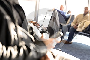 Passengers waiting at the airport/ Passengers using mobile phone