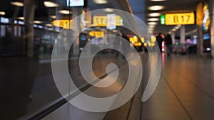 Passengers walking on flat elevator to terminal, hurry to flight, holiday trip