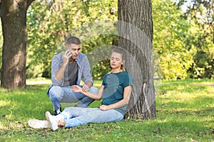 Passerby calling ambulance while checking pulse