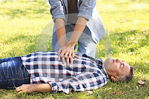 Passerby performing CPR on unconscious man