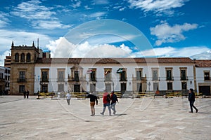 Passerby in the Simon Bolivar square in the city of Tunja. Colombia