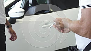 Passing the car key sold to the customer