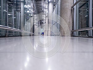 Passing daylight inside office building on modern glass building interior corridor