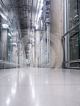 Passing daylight inside office building on modern glass building interior corridor