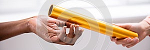 Passing Golden Relay Baton To Other Person