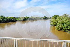 Passing over the bridge over river. The landscape of the river, the surface and the trees of the river\'s waterplain