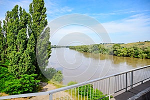 Passing over the bridge over river. The landscape of the river, the surface and the trees of the river\'s waterplain