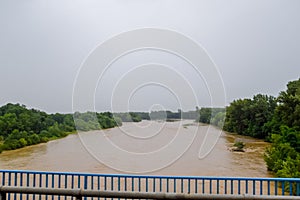 Passing over the bridge over river. The landscape of the river, the surface and the trees of the river\'s waterplain