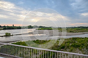 Passing over the bridge over river. The landscape of the river, the surface and the trees of the river\'s waterplain