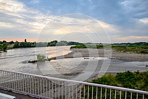 Passing over the bridge over river. The landscape of the river, the surface and the trees of the river\'s waterplain