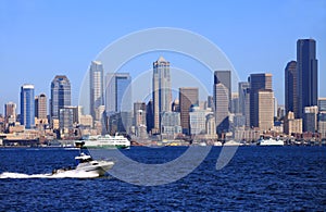 A passing power boat and the Seattle skyline.