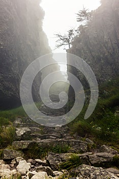 Passing a rock gorge with steep walls while hiking