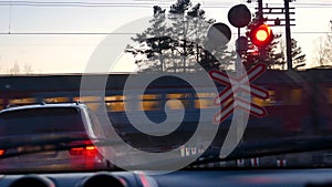 A passing train at a railway crossing.