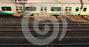 Passing train on the railway in Tokyo daytime top view.