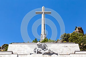 The passion of Christ statue and the big cross on the top of the Valley of the Fallen Valle de Los Caidos, Madrid, Spain photo