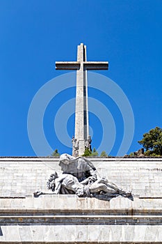 The passion of Christ statue and the big cross on the top of the Valley of the Fallen Valle de Los Caidos, Madrid, Spain photo