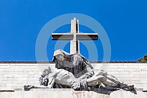 The passion of Christ statue and the big cross on the top of the Valley of the Fallen Valle de Los Caidos, Madrid, Spain photo