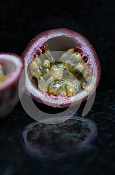 Passion fruit close up on black stone background