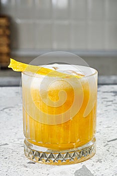 passion fruit cocktail on a gray stone bar counter