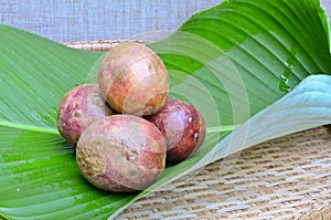 Passion fruit on green leaf