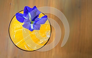 passion fruit juice decorat with butterfly pea flower on wood ba
