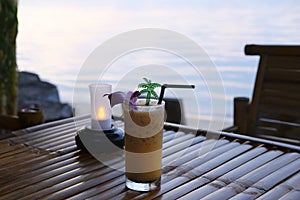 Passion fruit juice is placed on a wooden table, twilight sea background