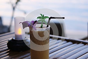 Passion fruit juice is placed on a wooden table, twilight sea background