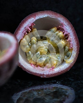 Passion Fruits close up on black stone background