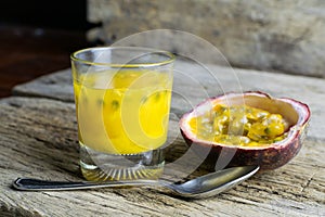 Passion fruits with glass of passion fruit juices on wooden