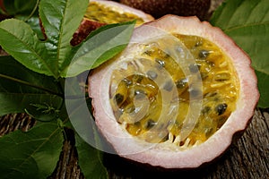 Passion fruits with leaves on wooden