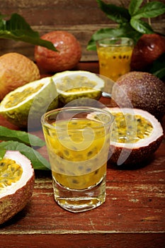 Passion fruits with leaves on wooden