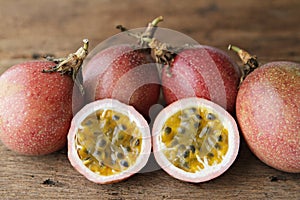 Passion fruits and slice on wooden.