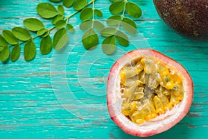 Passion fruits on wooden background,close up of fresh purple passion fruits harvest from farm,Half cut passion fruit.