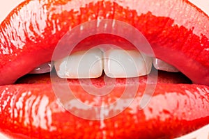 Passion. Sensual female lips. White healthy teeth. Mouth with teeth smile. Red lipstick and sexy kiss. Lips close up.