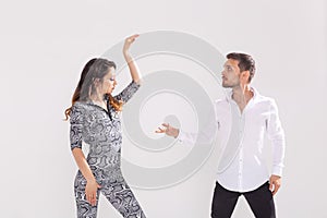 Passionate couple dancing social danse kizomba or bachata or semba or taraxia on white background with copy space