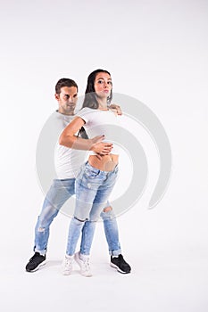 Passionate couple dancing social danse kizomba or bachata or semba or taraxia on white background