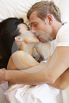 Passionate Couple Kissing In Bed