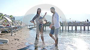 Passionate dancing, young couple in love having fun on beach at resort