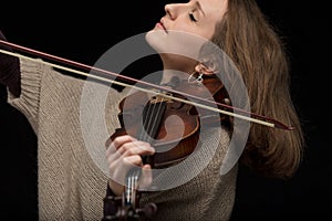 Passionate female violinist playing baroque guitar