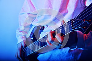 Passionate Guitarist Music Concept Photo. Electric Guitar Playing Closeup Photo. rock music band.