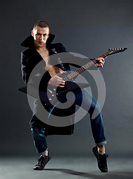 Passionate guitarist playing his electric guitar