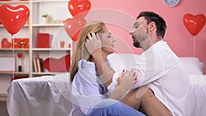 Passionate man tenderly kissing lady after romantic night, sweet love relations