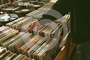 Hand picking old vinyl records from a shelf in a book store. photo