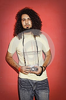 Passionate photographer serious with beautiful long curly hair h