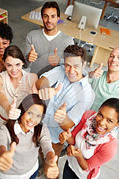 Passionate and positive about their service. High angle view portrait of a group of multi-ethnic people holding thumbs